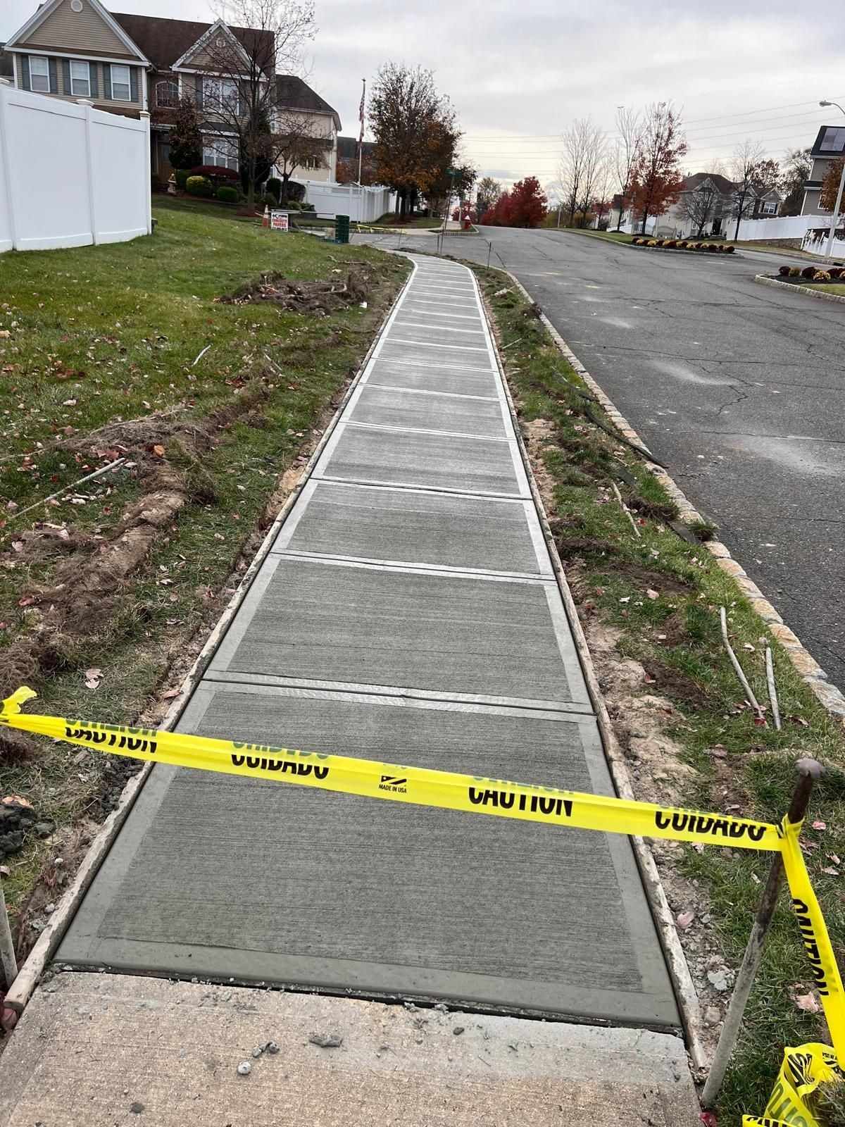 New concrete sidewalk with tooled joints along a residential street in New Jersey